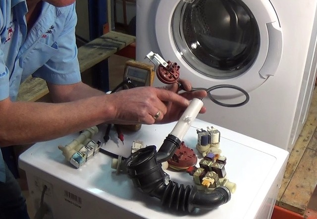 Expert technician servicing washing machine